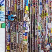 woman standing in front of thousands of products in a store cataloging them